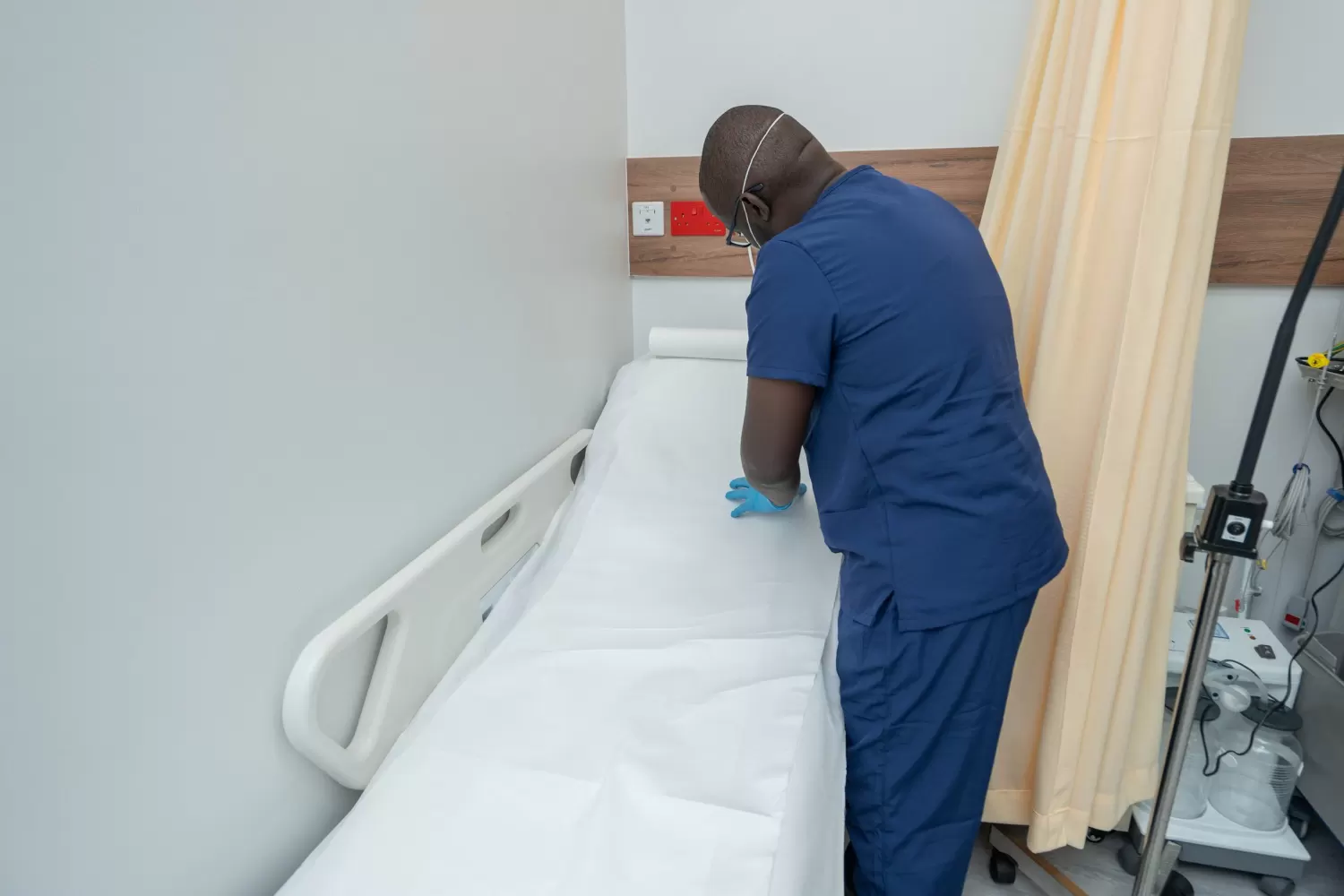 Nurse preparing a treatment bed at AmeriHealth Africa